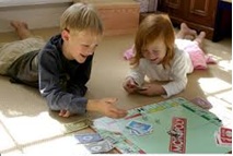 Children laughing around a board game